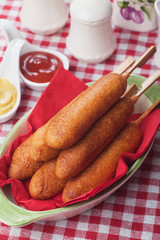 Corn dog with ketchup and mustard