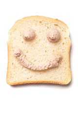 Pâté spread smiley on slice of bread