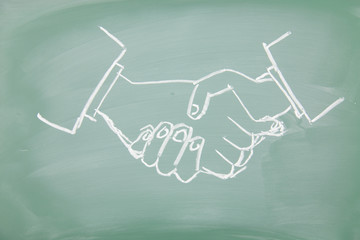 handshake drawn on a blackboard