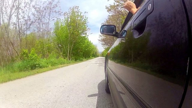 Driving black car on an urban road 