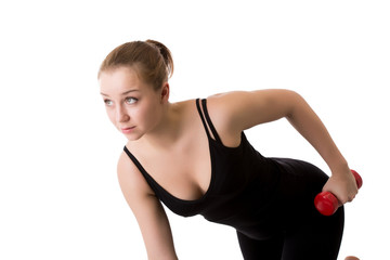 Portrait of sporty girl trains with dumbbells