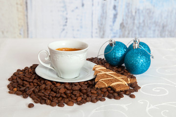 white cup of hot coffee with three blue christmas ball