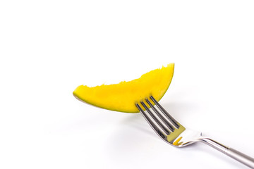 sliced mango on fork isolated