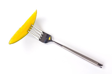 sliced mango on fork isolated