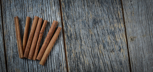 Cinnamon sticks on Rustic Wood Background