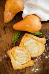 Triangle wraps of puff pastry with pear