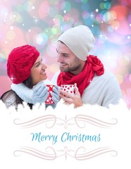 Composite image of winter couple holding mugs