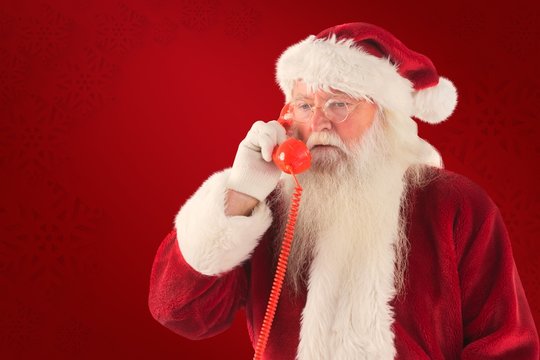 Composite image of santa on his red phone
