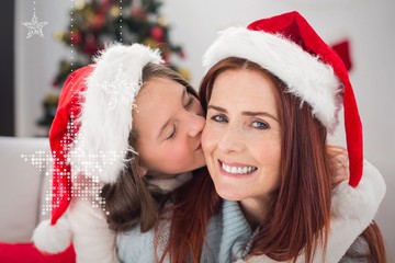 Composite image of festive mother and daughter on the couch