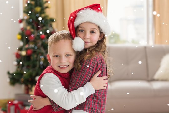 Composite image of festive siblings smiling at camera