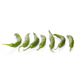Green chili peppers over white background