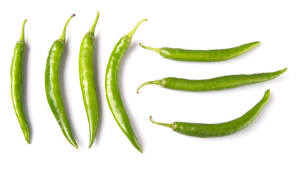 Green chili peppers over white background