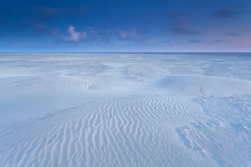 Fototapeta na wymiar sand pattern on beach at sunrise