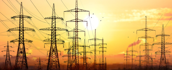 High-voltage power lines in an industrial area .On background su