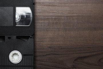 old retro video tapes over wooden background