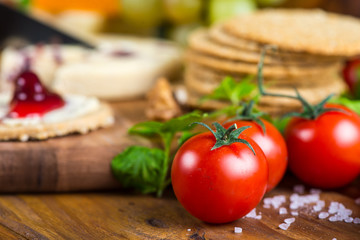 tomatoes with oat cakes and cheese in background