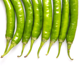 Green chili peppers over white background