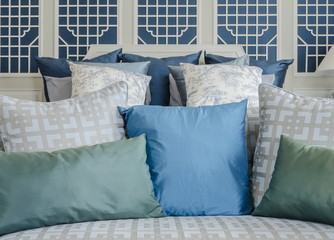 blue and green pillow on bed in luxury bedroom