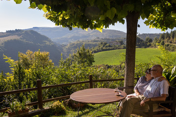 Happy elderly couple admires view of Tuscany