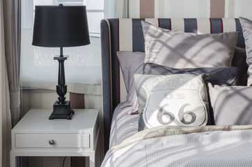 black lamp on grey table in bedroom at home