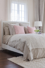 luxury bedroom with pink pillows on bed