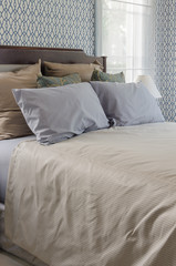 grey pillows on wooden bed in luxury bedroom