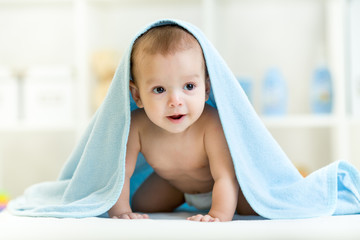 happy baby in towel indoor