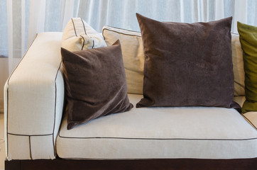 brown pillow on white sofa in living room