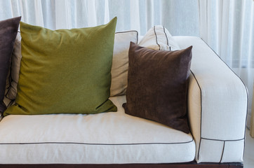 green pillow on white sofa in living room