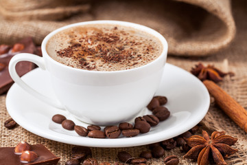 Latte coffee in a white cup with anise
