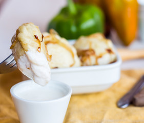 dumplings with potatoes in cream sauce, fried onions, Ukrainian