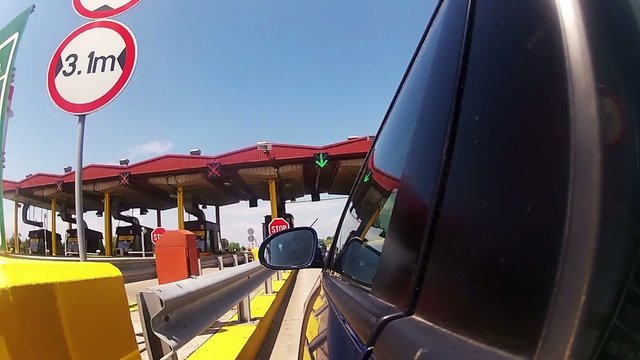 Highway driver pays road toll Booth 