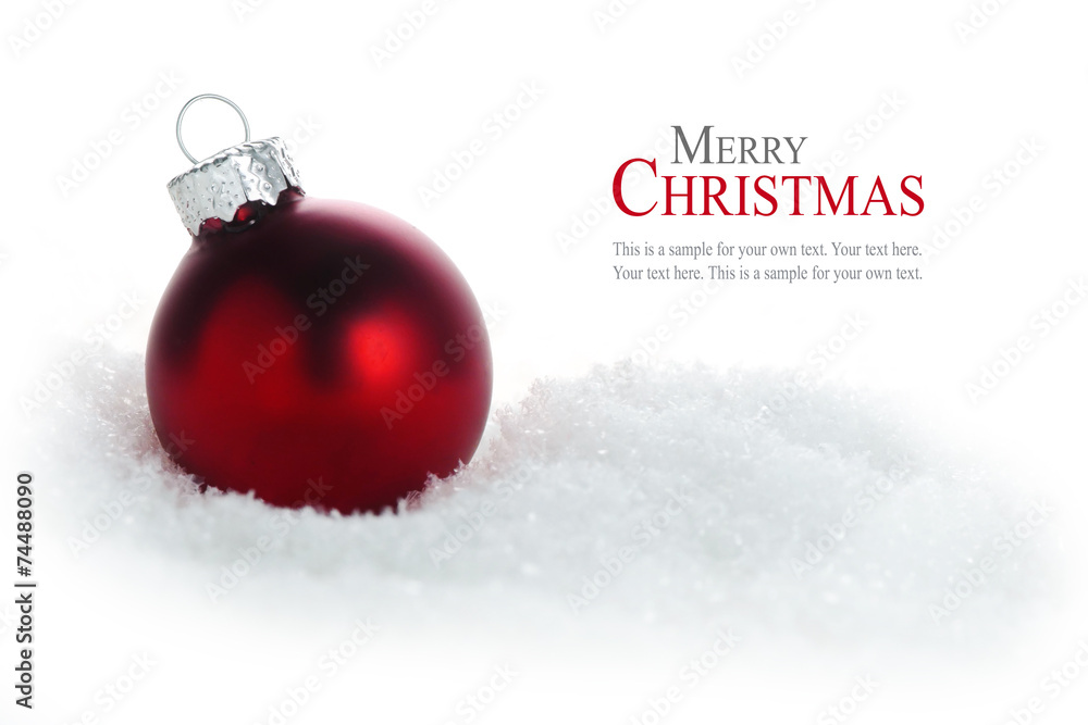 Wall mural red christmas ball in snow isolated on white background, sample