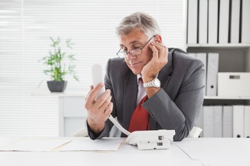 Smiling businessman put on hold