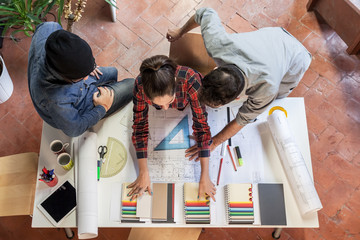 Teamwork. Three young architects working on a project