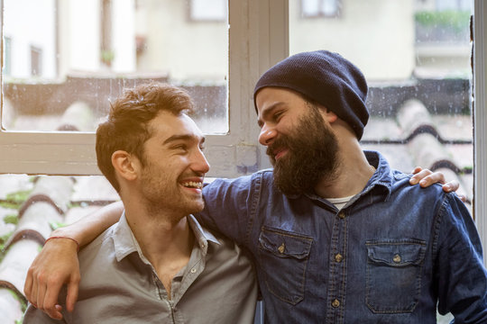 Couple of young men talking at the windows