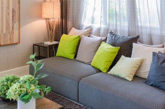 grey sofa and green pillows in living room