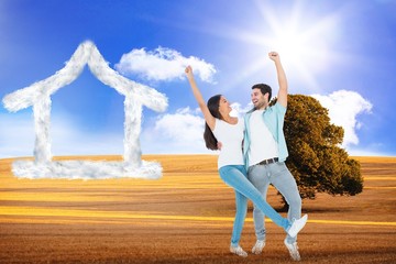 Fototapeta na wymiar Composite image of happy casual couple cheering together