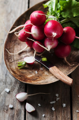 Fresh radish and salt on the wooden table