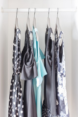 row of dress hanging on coat hanger in wardrobe