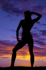 silhouette of woman in a bikini from back hand on head