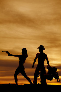 silhouette of woman in bikini side gun point