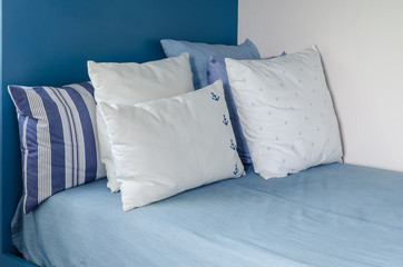 pillows on blue bed in kid bedroom