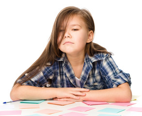 Girl is writing on color stickers