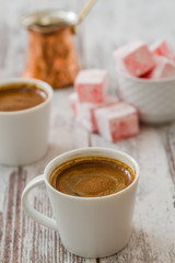 Turkish Coffee Cups with Turkish Delight on White Wooden Background