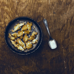 fried fish on a wooden background