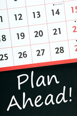 Plan Ahead! written on a blackboard next to a calendar