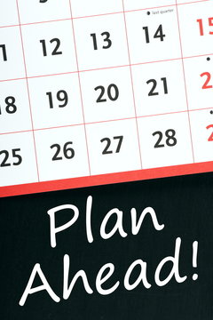 Plan Ahead! written on a blackboard next to a calendar