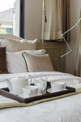 tray of white tea set in bedroom