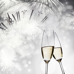 New Year's at midnight - champagne glasses and fireworks